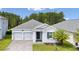 Charming home exterior with a three-car garage and well-maintained landscaping at 3052 Prelude Ln, Kissimmee, FL 34746