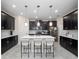Modern kitchen boasts an island with bar stools and sleek black cabinetry at 3052 Prelude Ln, Kissimmee, FL 34746