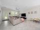 Bright living room with neutral walls, tile floors, and comfortable sectional sofa at 3052 Prelude Ln, Kissimmee, FL 34746