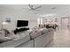 Open concept living room featuring a large sectional sofa and a modern entertainment center at 3052 Prelude Ln, Kissimmee, FL 34746