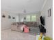 Bright living room with large sectional sofa, tile flooring, and ample natural light at 3052 Prelude Ln, Kissimmee, FL 34746