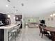 Open concept kitchen and living area with tile floors and natural light at 3052 Prelude Ln, Kissimmee, FL 34746