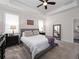 Serene main bedroom featuring a tray ceiling, plush carpet, and a cozy sitting area at 3052 Prelude Ln, Kissimmee, FL 34746