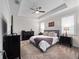 Main bedroom with tray ceiling, ceiling fan, and neutral decor at 3052 Prelude Ln, Kissimmee, FL 34746