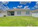 Backyard view of the home with a screened patio and lawn at 3062 Royal Tern Dr, Winter Haven, FL 33881