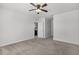 Neutral carpet bedroom with a ceiling fan and open doorway to the kitchen at 3062 Royal Tern Dr, Winter Haven, FL 33881