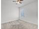 Bright bedroom featuring carpet flooring, ceiling fan, and window view at 3062 Royal Tern Dr, Winter Haven, FL 33881