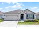 Charming single-story home featuring a two-car garage, well-manicured lawn, and inviting front entrance at 3062 Royal Tern Dr, Winter Haven, FL 33881