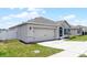 Charming single-story home featuring a two-car garage, well-manicured lawn, and inviting front entrance at 3062 Royal Tern Dr, Winter Haven, FL 33881