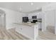 Bright kitchen featuring white cabinets, an island with sink, and stainless steel appliances for cooking enjoyment at 3062 Royal Tern Dr, Winter Haven, FL 33881