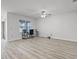 Spacious living room with wood-look floors, fan, and natural light perfect for relaxing and entertaining at 3062 Royal Tern Dr, Winter Haven, FL 33881