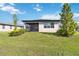 Well-maintained backyard with lush green grass, screened patio, and attractive landscaping at 3224 Oxbow Ct, Harmony, FL 34773
