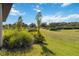 Beautiful backyard featuring lush green grass and meticulously landscaped plants, creating a serene view at 3224 Oxbow Ct, Harmony, FL 34773