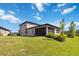 Expansive backyard showcasing a screened patio, well-kept lawn, and vibrant landscaping at 3224 Oxbow Ct, Harmony, FL 34773