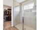 Bathroom featuring a glass-enclosed shower, open to the walk-in closet at 3224 Oxbow Ct, Harmony, FL 34773