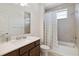 Well-lit bathroom features a large vanity with a white countertop and a shower-tub combination at 3224 Oxbow Ct, Harmony, FL 34773