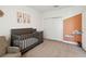Bedroom with modern gray crib, white closet, and colorful artwork at 3224 Oxbow Ct, Harmony, FL 34773