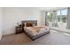 Bright bedroom features a cozy bed with decorative pillows, and a large window with natural light at 3224 Oxbow Ct, Harmony, FL 34773