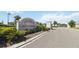 Elegant community entrance with stone signage and manicured landscaping welcomes residents and guests at 3224 Oxbow Ct, Harmony, FL 34773