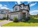 Beautifully landscaped home with a two-car garage and brick-paved driveway at 3224 Oxbow Ct, Harmony, FL 34773