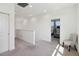 Open upstairs hallway with neutral carpet, leading to the bedrooms and a comfortable sitting area at 3224 Oxbow Ct, Harmony, FL 34773