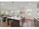 Bright open-concept kitchen featuring a large island, stainless appliances, and modern finishes at 3224 Oxbow Ct, Harmony, FL 34773