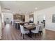 Open floor plan with modern kitchen, large island, stainless appliances, and adjacent dining area at 3224 Oxbow Ct, Harmony, FL 34773