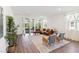 Spacious living room with hardwood floors, a leather couch, and large glass sliding doors at 3224 Oxbow Ct, Harmony, FL 34773