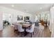 Open-concept living and dining area with hardwood floors, ample natural light, and modern decor at 3224 Oxbow Ct, Harmony, FL 34773