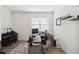 Bright home office with a large window, neutral walls, and built-in shelving at 3224 Oxbow Ct, Harmony, FL 34773
