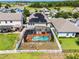 Aerial view showcasing a home with solar panels, a screened pool, and a spacious backyard at 3420 Middlebrook Pl, Harmony, FL 34773