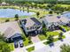 Aerial view of home with solar panels, a pond, and a well-maintained neighborhood at 3420 Middlebrook Pl, Harmony, FL 34773