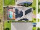 Aerial shot of a home with solar panels, a screened-in pool, and fenced backyard at 3420 Middlebrook Pl, Harmony, FL 34773