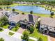Aerial view of home with solar panels, a lake view, and a well-manicured lawn at 3420 Middlebrook Pl, Harmony, FL 34773
