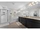 Bright bathroom with double vanities, separate tub, shower, and modern fixtures at 3420 Middlebrook Pl, Harmony, FL 34773