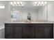 Elegant bathroom with a granite countertop, double vanity, and a well-lit mirror at 3420 Middlebrook Pl, Harmony, FL 34773