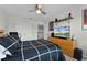 Bedroom featuring a ceiling fan, television and a modern black and white bed set at 3420 Middlebrook Pl, Harmony, FL 34773