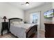 Cozy bedroom with wood-look floors, a ceiling fan, and ample natural light at 3420 Middlebrook Pl, Harmony, FL 34773