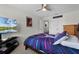 Bedroom with a modern blue bedspread and a television on a stand at 3420 Middlebrook Pl, Harmony, FL 34773