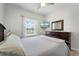 Relaxing bedroom overlooking the pool area with wood-look floors, ceiling fan, and natural light at 3420 Middlebrook Pl, Harmony, FL 34773