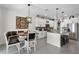 Dining area open to the kitchen featuring stylish seating, an island with bar stools, and modern appliances at 3420 Middlebrook Pl, Harmony, FL 34773