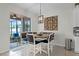 Charming dining area featuring stylish seating, sliding glass doors to an outdoor patio, and an oversized decorative clock at 3420 Middlebrook Pl, Harmony, FL 34773