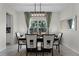 Bright dining room featuring a modern chandelier, a large window, and a stylish dining set for six at 3420 Middlebrook Pl, Harmony, FL 34773