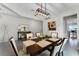 Bright dining room featuring a modern chandelier, a large window, and a stylish dining set for six at 3420 Middlebrook Pl, Harmony, FL 34773