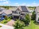 Attractive two-story home featuring well-manicured landscaping and solar panels at 3420 Middlebrook Pl, Harmony, FL 34773