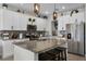 Contemporary kitchen with a large island, granite countertops, stainless steel appliances, and ample cabinet space at 3420 Middlebrook Pl, Harmony, FL 34773