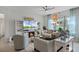 Cozy living room with a fireplace, built-in shelves, comfortable seating, and plenty of natural light at 3420 Middlebrook Pl, Harmony, FL 34773
