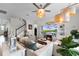 Comfortable living room with a fireplace, large screen TV, stylish decor, and an open staircase at 3420 Middlebrook Pl, Harmony, FL 34773