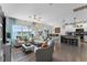 Bright and airy living room featuring modern furnishings and an open floor plan to the kitchen and dining area at 3420 Middlebrook Pl, Harmony, FL 34773