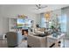 Cozy living room with a fireplace, built-in shelves, comfortable seating, and plenty of natural light at 3420 Middlebrook Pl, Harmony, FL 34773